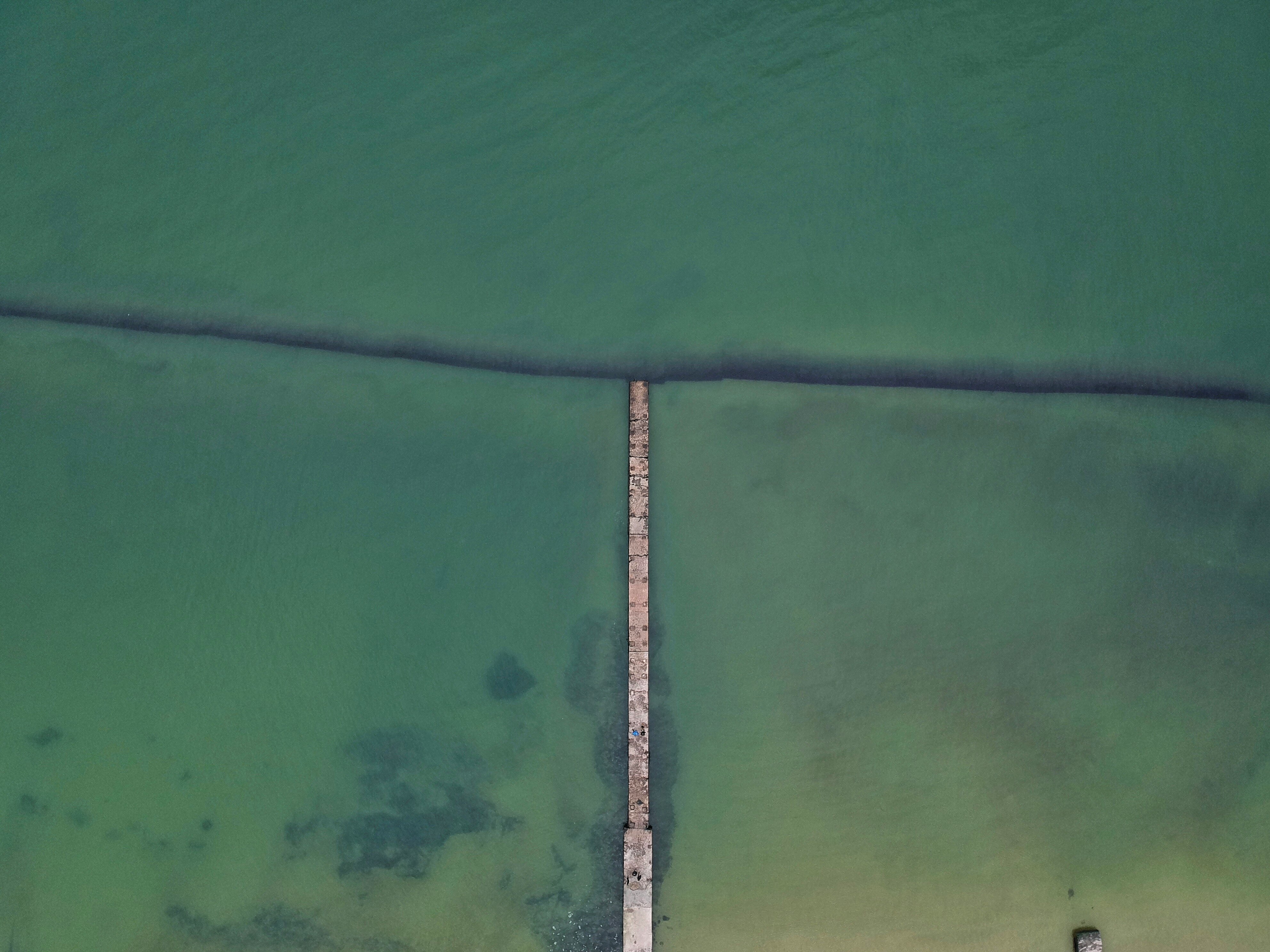 aerial photograph of sea and bridge